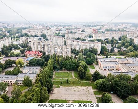 Aerial View Of Town With Socialist Soviet Panel Building At Cloudy Day. Buildings Were Built In The 
