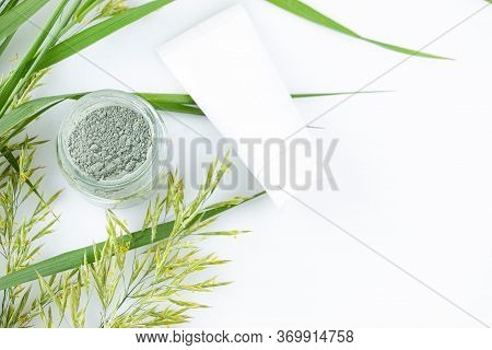 Green Clay Powder In A Glass Jar - For Face And Body Skin Care - On A White Background, Top View. Sp
