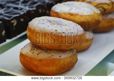 White Chocolate Coated Donut Or Doughnut With Springles  In Close Up