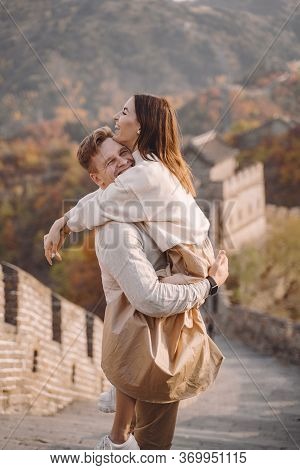 Beautiful Young Couple Hugging At The Great Wall Of China
