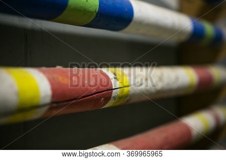 Stack Of Equestrian Jumping Poles In Various Colors