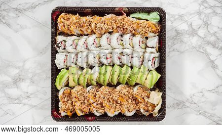 Flat Lay. Pre-packaged Variety Of Sushi And Sushi Rolls In A Plastic Tray.