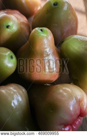 Close Up Rose Apple Or Jambu On Dark Background Under Sunlight. Thailand Apple Tropical Fruit Flavor