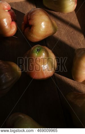 Close Up Rose Apple Or Jambu On Dark Background Under Sunlight. Thailand Apple Tropical Fruit Flavor