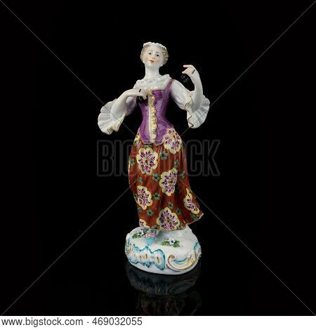 Figurine Of An Elephant On A Black Background With Reflection. Antique Porcelain Figurine Of An Elep