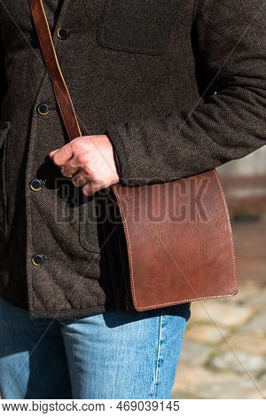 Close-up Photo Of Brown Messanger Leather Bag On Mans Shoulder