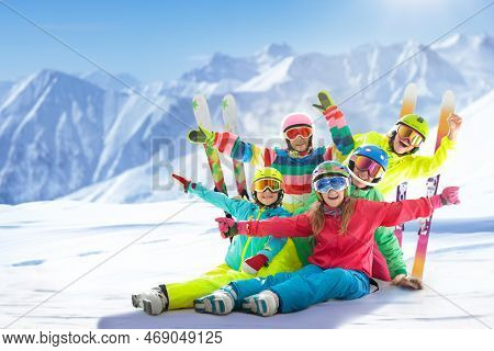Family In Winter Mountains. Ski And Snow Vacation.