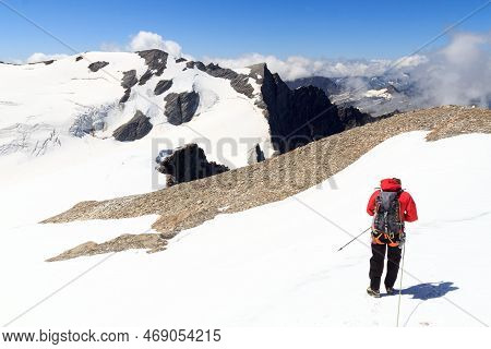 Man Mountaineering With Crampons On Glacier Pasterze And Snow Mountain Panorama In Glockner Group, A