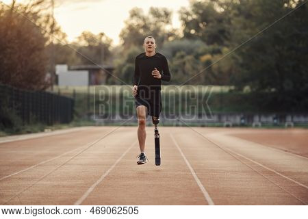A Fit Sportsman With Artificial Leg Running At The Stadium.