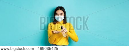 Covid-19, Social Distancing And Pandemic Concept. Smiling Asian Woman In Medical Mask Using Preventi