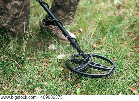 Soldier Using A Metal Detector In Fields. Ukrainian Explosive Ordnance Disposal Officer Detecting Me
