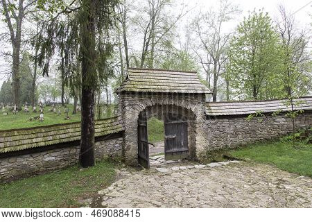Radruz, Poland - May 5, 2013: Stone Wall Surrounding The Oldest Orthodox Church In Poland And View O