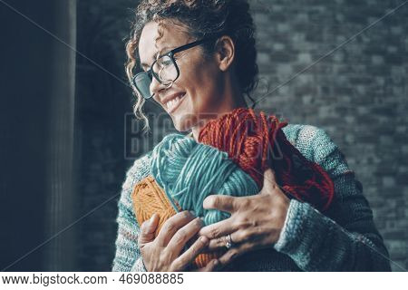 One Woman With Pleasure Expression On Face Holding With Love A Bunch Of Wool Balls In Different Colo