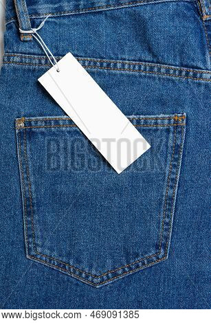 Back Side Pocket And Price Tag Of Blue Jeans Pants Close-up. Denim Background, Texture, Mockup. Fash