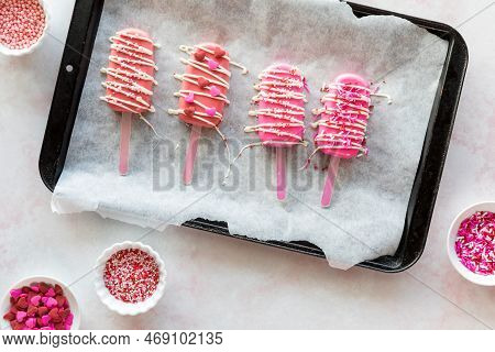 Valentine Cakesicles Decorated With Candy Melt Drizzle And Sprinkles.