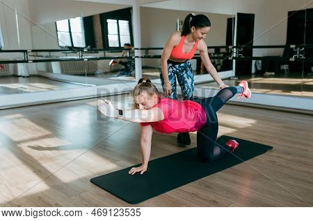Fitness Trainer And Mentee Over Gym Room Background. Sport And Healthy Active Lifestyle Concept. Ind
