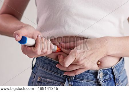 Epinephrine Shot Syringe. Woman Injecting Anaphylactic Shock Hormone