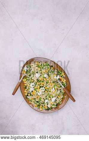 Salad Of Vegetables, Pasta And Mozzarella In A Dish On A Light Background. Top View.
