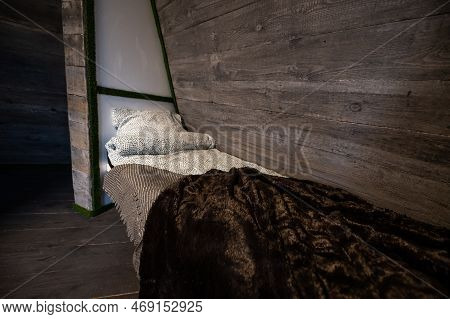 Single Bed With Clean Linen In Bedroom Niche Of Wooden Cabin. Pyramid Shape Bungalow Summer House. A