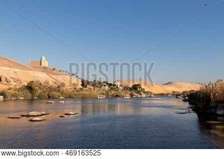 Beautiful Landmark Of Nile River Bank Shore With Traditional Construction Village In The Desert Dune