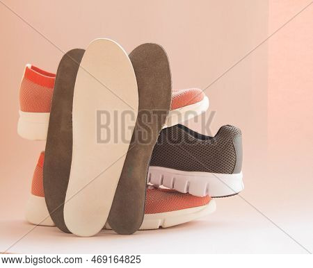 Medical Orthopedic Insoles With Colorful Sport Shoes Isolated On A Neutral Background. Аccessories F
