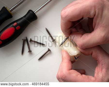 Woodworker Rubbing Some Candle Wax On The Screws Before Driving Them Into Wood Joints. Wax Coating S