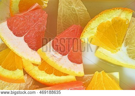 Slices Of Grapefruit, Orange And Pomelo In Water On White Background. Pieces Of Grapefruit, Orange F