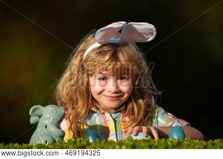 Child With Easter Eggs In Basket Outdoor. Easter Egg Hunt. Fynny Kids Portrait. Happy Easter Day. Ki