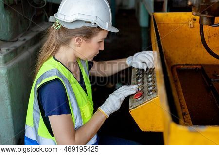 Woman Engineer Wear Hardhat Working At Machine In Factory. Female Technician Control Metalwork Lathe