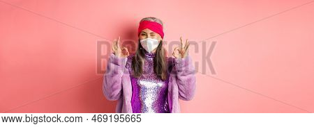 Covid-19, Pandemic And Fashion Concept. Awesome Asian Grandmother Wearing Stylish Disco Dress And Re