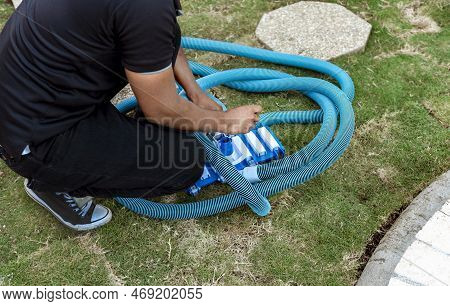 Man Connecting The Handle On The Pool Vacuum. Suction Equipment Connection For Swimming Pool, Pool S