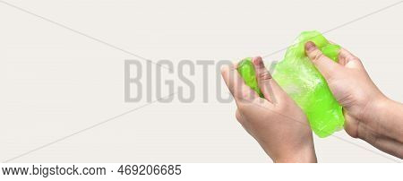 Hand Playing With Textured Slime On White Background. Teen Hand Holding Green Shining Slime With Bub
