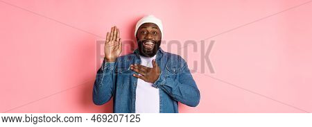 Image Of Smiling African-american Man Being Honest, Telling Truth, Hands On Heart And In Air, Making