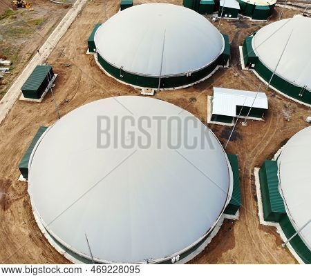 Biogas. Aerial View Of A Biogas Plant And A Farm In Green Fields. Renewable Energy From Biomass. Mod
