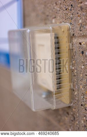 Selective Focus On Covered Thermostat That Is Locked To Prevent Changing Temperatures