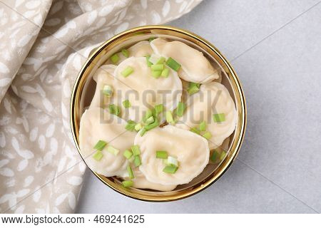 Cooked Dumplings (varenyky) With Tasty Filling And Green Onion On Light Table, Top View