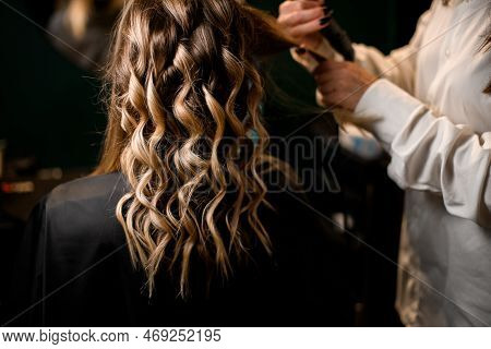 Selective Focus On Beautiful Curled Strands Of Hair. Hairstyle