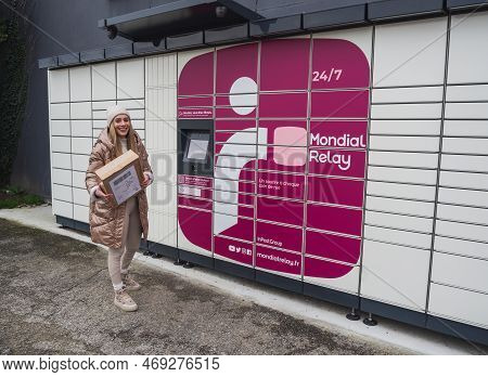Loriol Sur Drome, France - January 14, 2023: Picking Up A Parcel From A Mondial `relay Locker By A Y