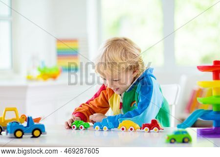 Boy Playing Toy Cars. Kid With Toys. Child And Car