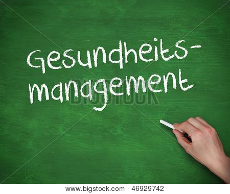 Hånden skriver gesundheits management på en grøn board