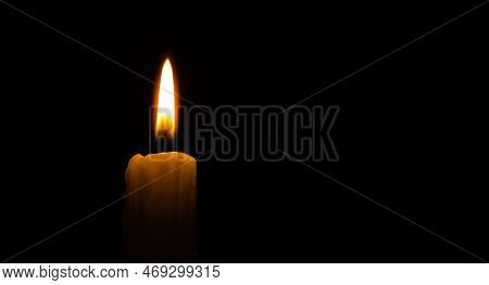 Banner Size Image Of Burning Candle Against A Black Background With Free Copy Space For Text