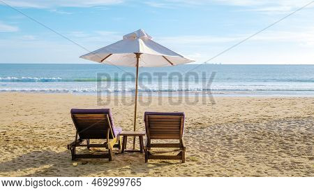 Beach Chairs On The Beach Of Koh Lanta, Beach Chairs With Umbrella By A Pool