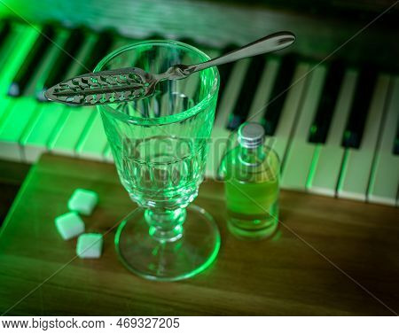 Drinking Absinthe Using Traditional Method With Slotted Spoon, Authentic Glassware And Sugar Cubes, 