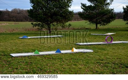Minigolf Course In Park Catch Golf Balls Behind Obstacle. Game For Points Below Par Or Above Par, Re