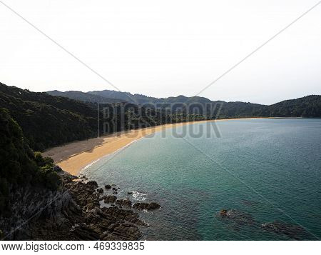 Elevated View Of Tropical Pacific Ocean Beach Surrounded By Lush Green Nature In Abel Tasman Nationa