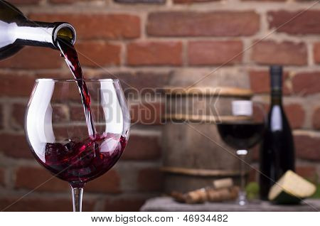 Glass Of Wine Against A Brick Wall
