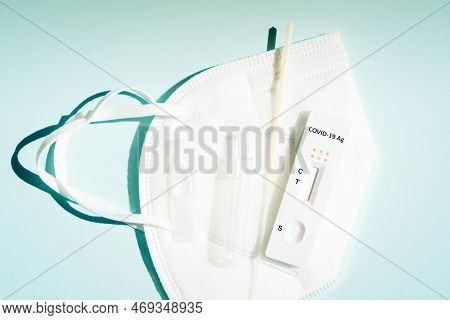 Nasal Antigen Covid 19 Test With White Ffp 2 Mask On Blue Background, Top View