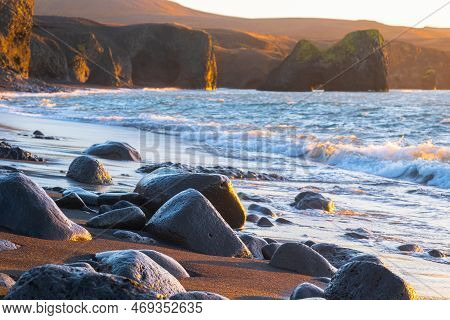 Scenic Beach With Black Sand By Low Tide At Sunset Near Kopasker Village, Volcanic Coastline In Icel