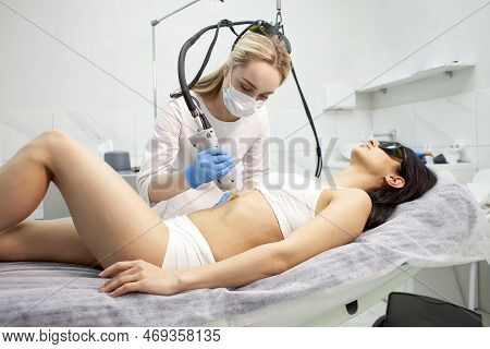 Epilation Of The Abdomen In A Cosmetology Clinic. Doctor Cosmetologist Makes A Procedure For Removin