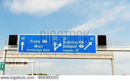 Signage Blue Traffic On The Expressway With Inscription Praha, Wien, Simmeringer Haide, Bratislava, 